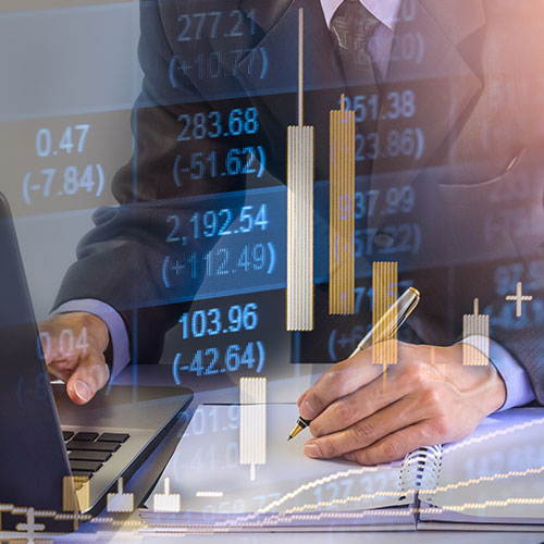 Man working at desk with graph overlay