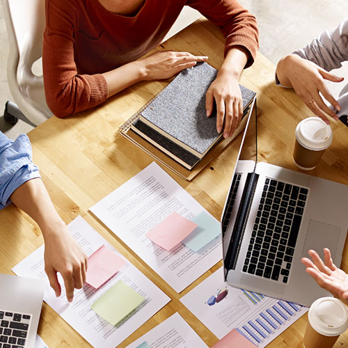Closeup of practitioners working on desk