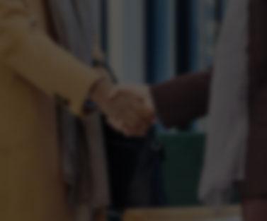 Blurred background of man shaking woman's hand